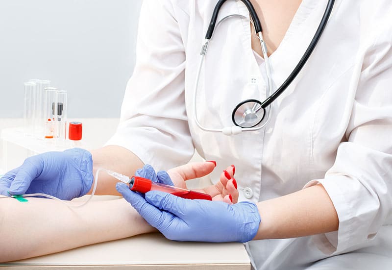 patient gives blood analysis medical laboratory syringe hands nurse closeup